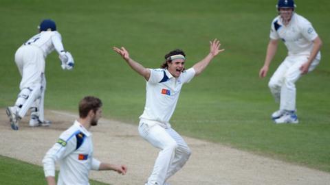 A game of cricket in action