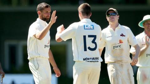 Mark Adair celebrates after bowling Fintan McAllister