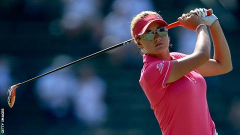 Boulden playing golf in a pink outfit