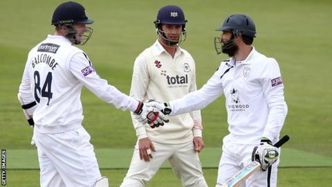 James Tomlinson (right) is congratulated by David Balcombe after reaching 50