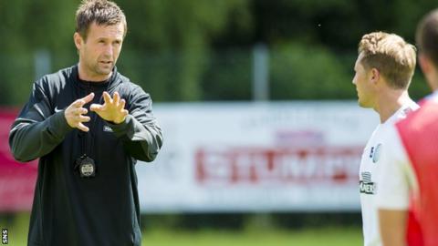 Celtic manager Ronny Deila talks to some of his players during training