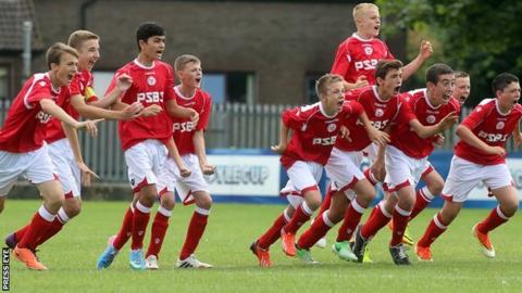 Shelbourne players race from the centre circle after winning the Under-14 plate final on penalties