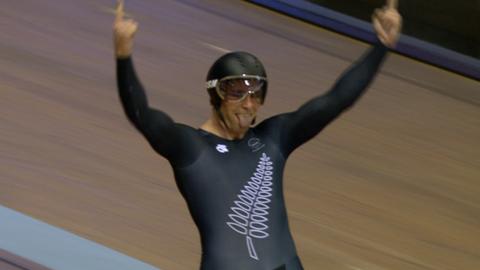 A New Zealand track cyclist celebrates after winning gold in the Men's Team Sprint at the 2014 Commonwealth Games in Glasgow
