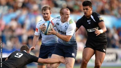 Dan Fish of Cardiff Blues is tackled by Chris Williams of Ospreys