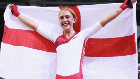 Laura Trott waves a St George's flag after winning the points race