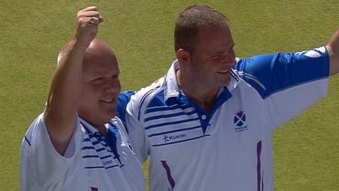 Scotland bowlers Paul Foster and Alex Marshall celebrate beating Malaysia