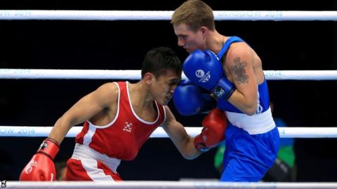 Wales' Ashley Williams (right) guaranteed himself a medal after beating Malaysia's Muhamad Fuad Mohd Redzuan in the men's light-flyweight quarter-final