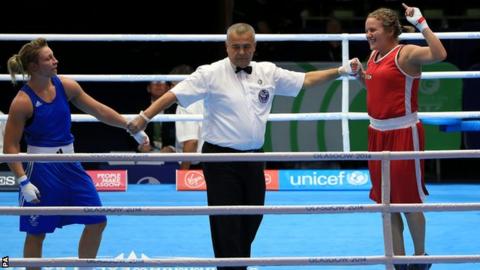 Canada's Ariane Fortin (red) celebrates her win against Wales's Lauren Price in the women's middleweight semi-finals