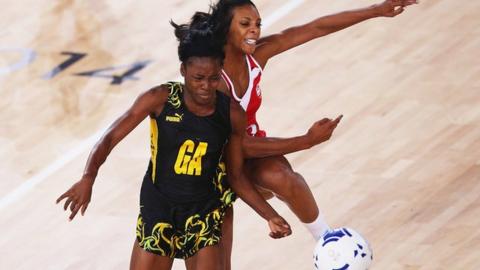 Jamaica and England netball players compete for the ball at the 2014 Commonwealth Games in Glasgow