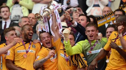 Cambridge United celebrate winning promotion from the Conference