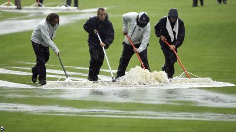 Ground workers clear water off the fairway during the second round at Valhalla