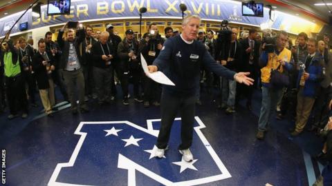 Head coach Pete Carroll of the Seattle Seahawks gives his team a speech in the locker room after the Super Bowl XLVIII
