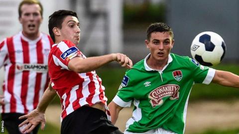 Derry's Shaun Kelly and Cork forward Josh O'Shea battle for possession