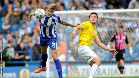 Sheffield Wednesday's Glenn Loovens heads clear
