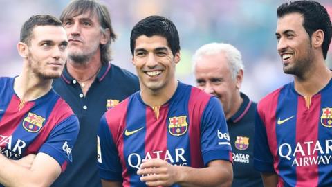 Luis Suarez with team mates Vermaelen