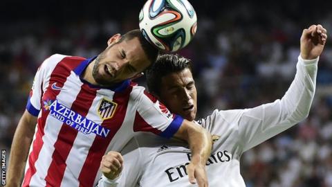 Ronaldo vies for the ball with Atletico Madrid midfielder Mario Suarez