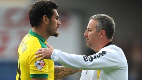 Neil Adams celebrates with Bradley Johnson after Norwich's 1-0 win over Ipswich.