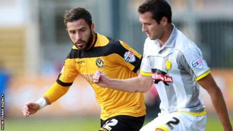 Robbie Willmott of Newport County is tackled by Phil Edwards of Burton Albion