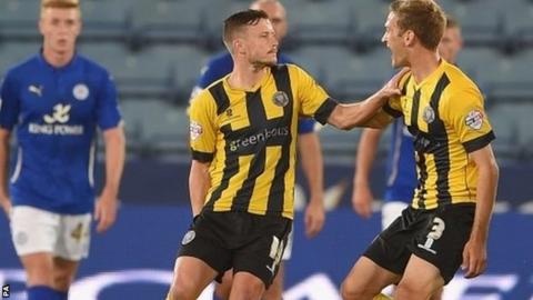 Andrew Mangan (left) of Shrewsbury pulls up injured while celebrating