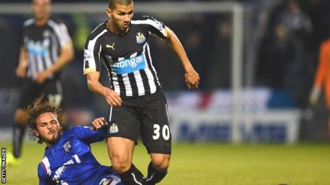 Newcastle's Mehdi Abeid tackled by Bradley Dack of Gillingham