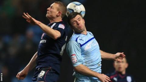 Stuart Beavon (left) challenges Coventry City's Steven Jennings