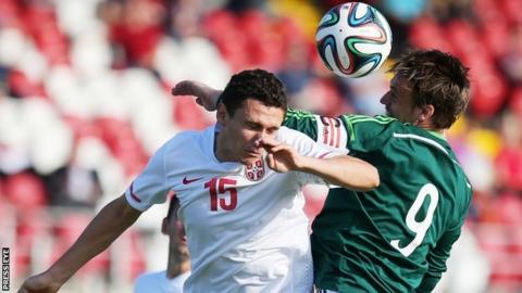Milos Veljkovic and James Gray in aerial action at Shamrock Park
