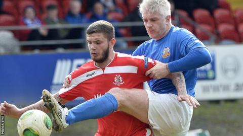 William Murphy gets his foot in ahead of Portadown striker Darren Murray
