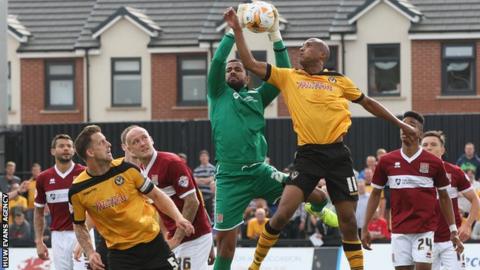 Newport's Chris Zebroski challenges Northampton's Jordan Archer