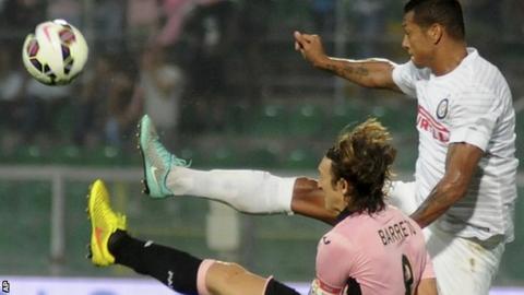 Inter's Fredy Guarín, right, challenges for the ball with Palerm's Edgar Barreto