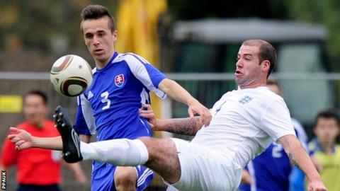 England's Mark Wolfenden (St Mary's) is tackled by Slovakia's Robert Dicky .
