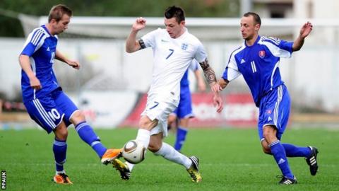England's Lee Gale (Peel FC) is tackled by Slovakia's Rudolf Bilas