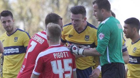 Michael Raynes of Oxford United screams at Joe Pigott of Newport County following a tackle