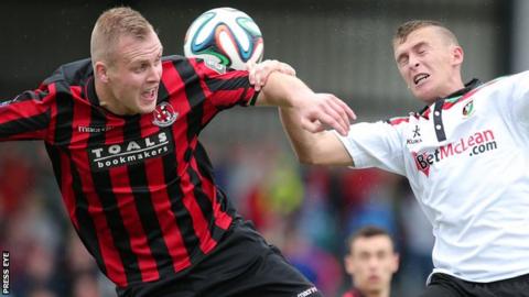 Crusaders striker Jordan Owens and Glentoran's Jay Magee tussle for the ball
