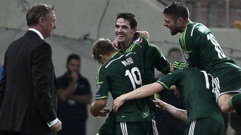 Kyle Lafferty is embraced after scoring Northern Ireland's second goal against Greece