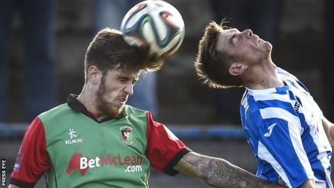 Glentoran's Stephen McCullough beats Ian Parkhill to the high ball at the Showgrounds