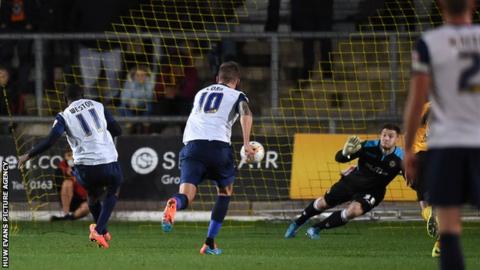 Newport County goalkeeper Joe Day dives to keep out the penalty of Southend's Myles Weston