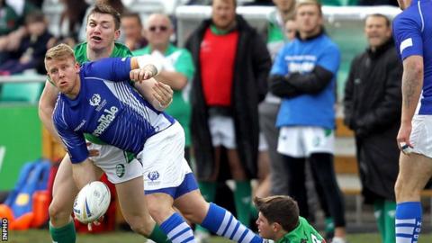 Scotland's Alex Hurst tries to get the ball away as he is tackled in Tallaght