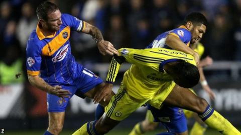 Shrewsbury Town skipper Liam Lawrence gets to grips with Didier Drogba