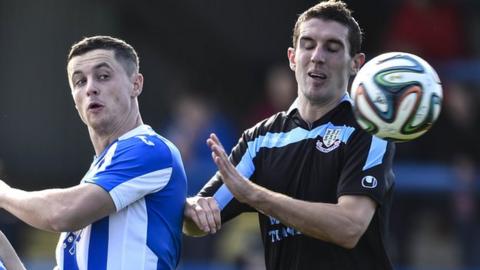 Coleraine's Ruairi Harkin challenges Ballymena United striker Gary Thompson
