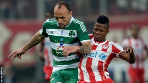 Olympiakos striker Michael Olaitan (right)