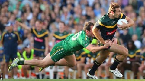 Michael Murphy attempts to halt the progress of Jobe Watson in Perth