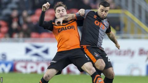 Paul Paton of Dundee United battles with Alexei Eremenko of Kilmarnock