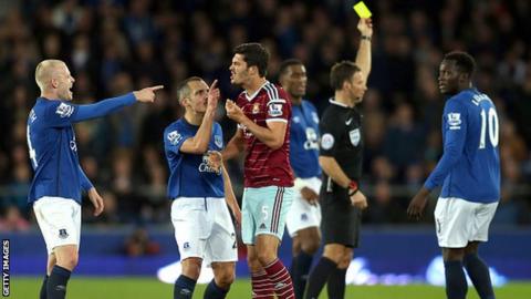 West Ham's James Tomkins surrounded by Everton players