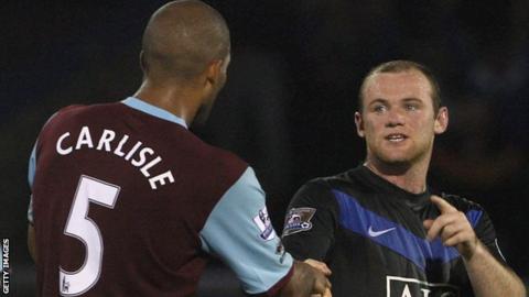 Carlisle shakes hands with Wayne Rooney after a game between Burnley and Manchester United