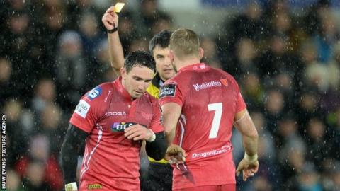 Kristian Phillips (L) is sent to the sin-bin by referee Marius Mitrea during the Scarlets' defeat by Ospreys