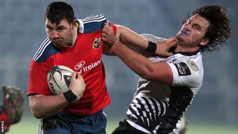 Munster's Paddy Butler with a hand-off on Zebre opponent Jacopo Sarto