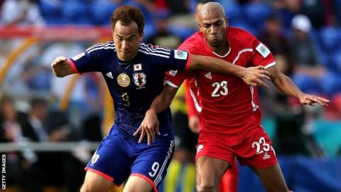 Shinji Okazaki (left) in action for Japan in the Asian Cup against Palestine