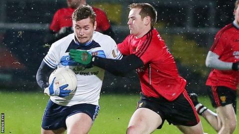 Caolan Mooney of Ulster University battles with Down's Peter Fitzpatrick