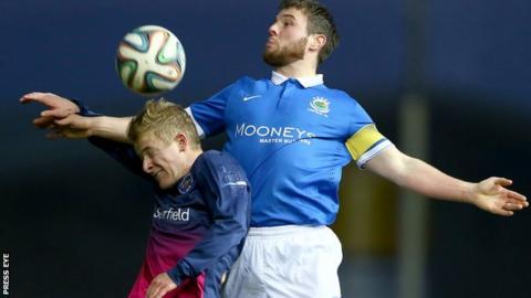 John Currie of Ballinamallard and Linfield's Jamie Mulgrew