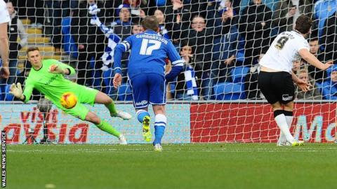 Cardiff goalkeeper Simon Moore saves Derby striker Chris Martin's penalty